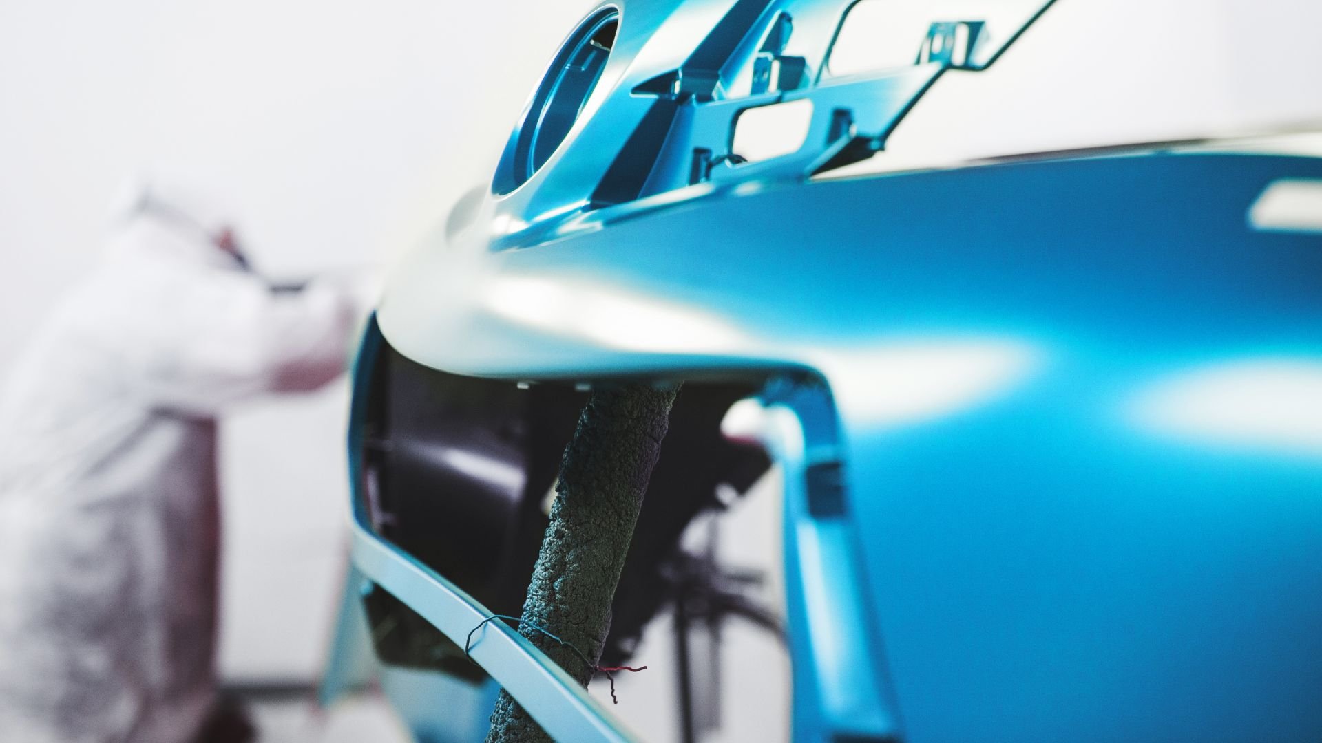 Close-up of sleek blue sports car with glossy metallic paint